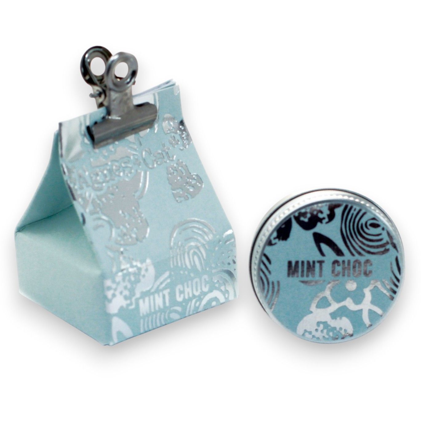A 20g round tin of mint chocolate scented lip balm shown with its teal and brown festive dessert-themed gift box.