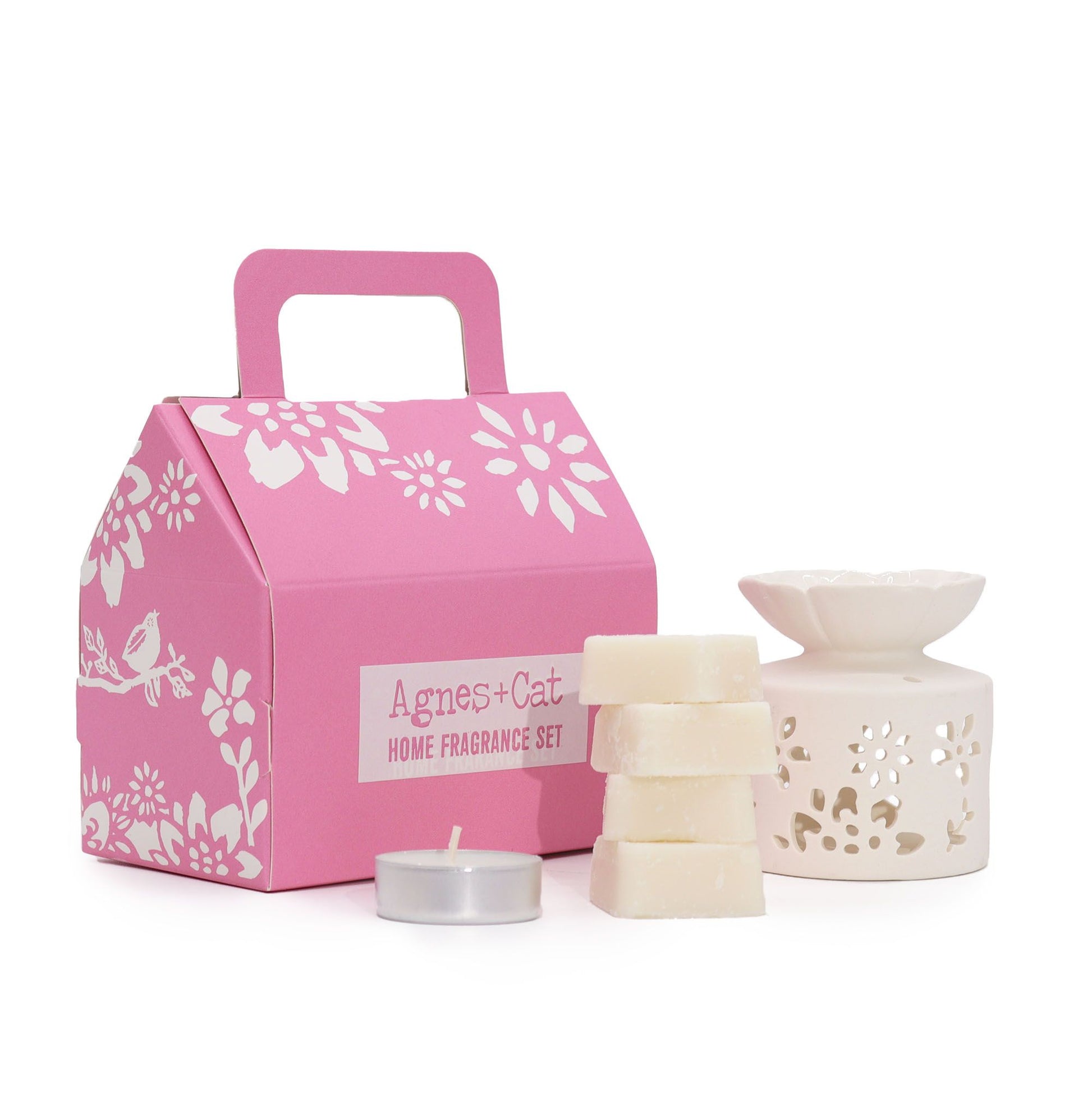 A charming pink gift box featuring a selection of rose and tea leaf-inspired bath treats and aromatic essentials.