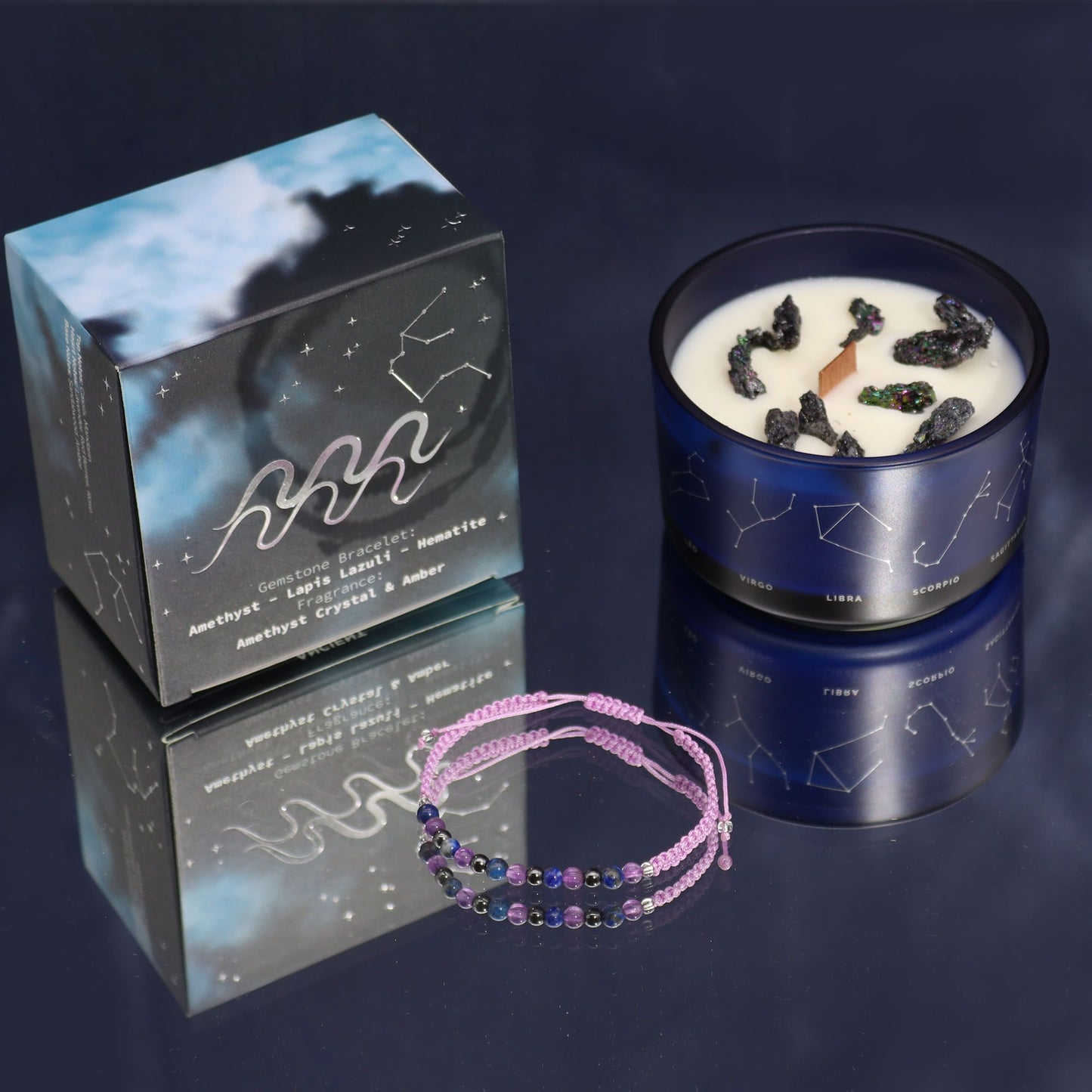 A luxury black candle tin with gold Aquarius constellation artwork, displayed with a surprise semi-precious stone bracelet reveal.