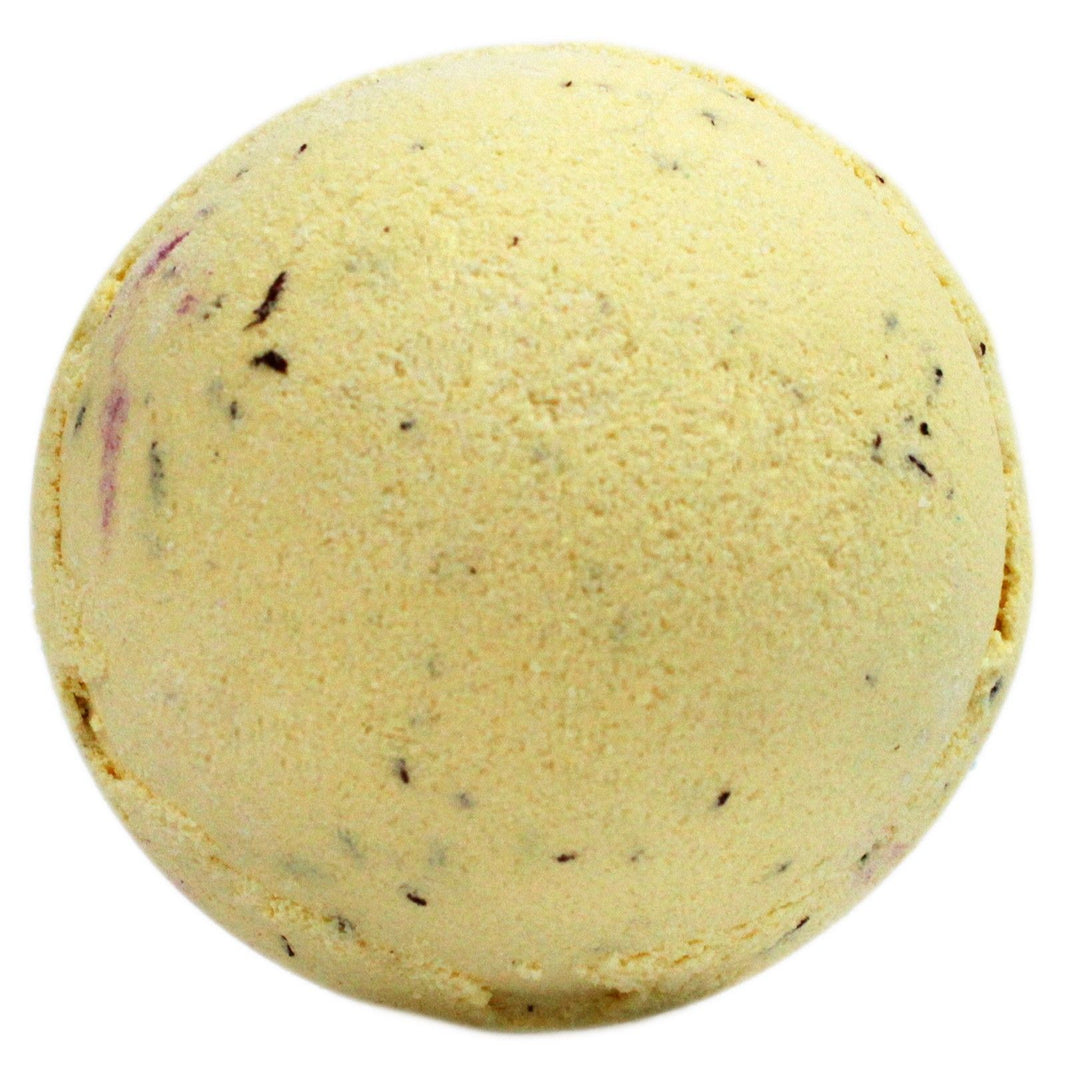 A large, round yellow bath bomb with brown speckles, mimicking the look of a classic banoffee pie dessert.