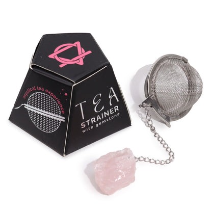 Silver stainless steel tea infuser ball on a chain with a raw pink Rose Quartz gemstone charm attached.