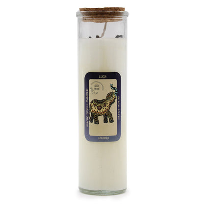 A white ritual pillar candle with a 'Luck' label featuring traditional mystical symbols for good fortune.