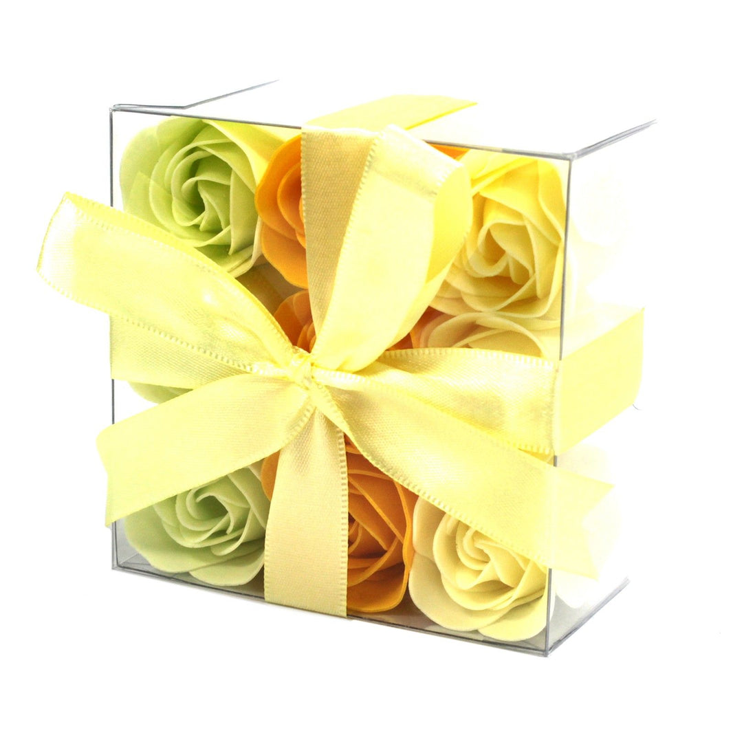 A square gift box containing nine realistic soap roses in yellow and cream spring shades.