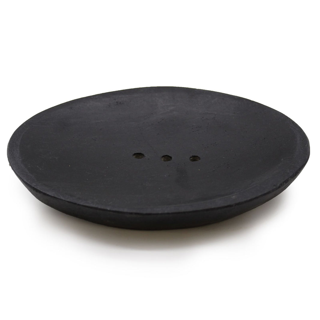 A sleek, oval-shaped soap dish carved from solid black natural marble with subtle, elegant stone veining.