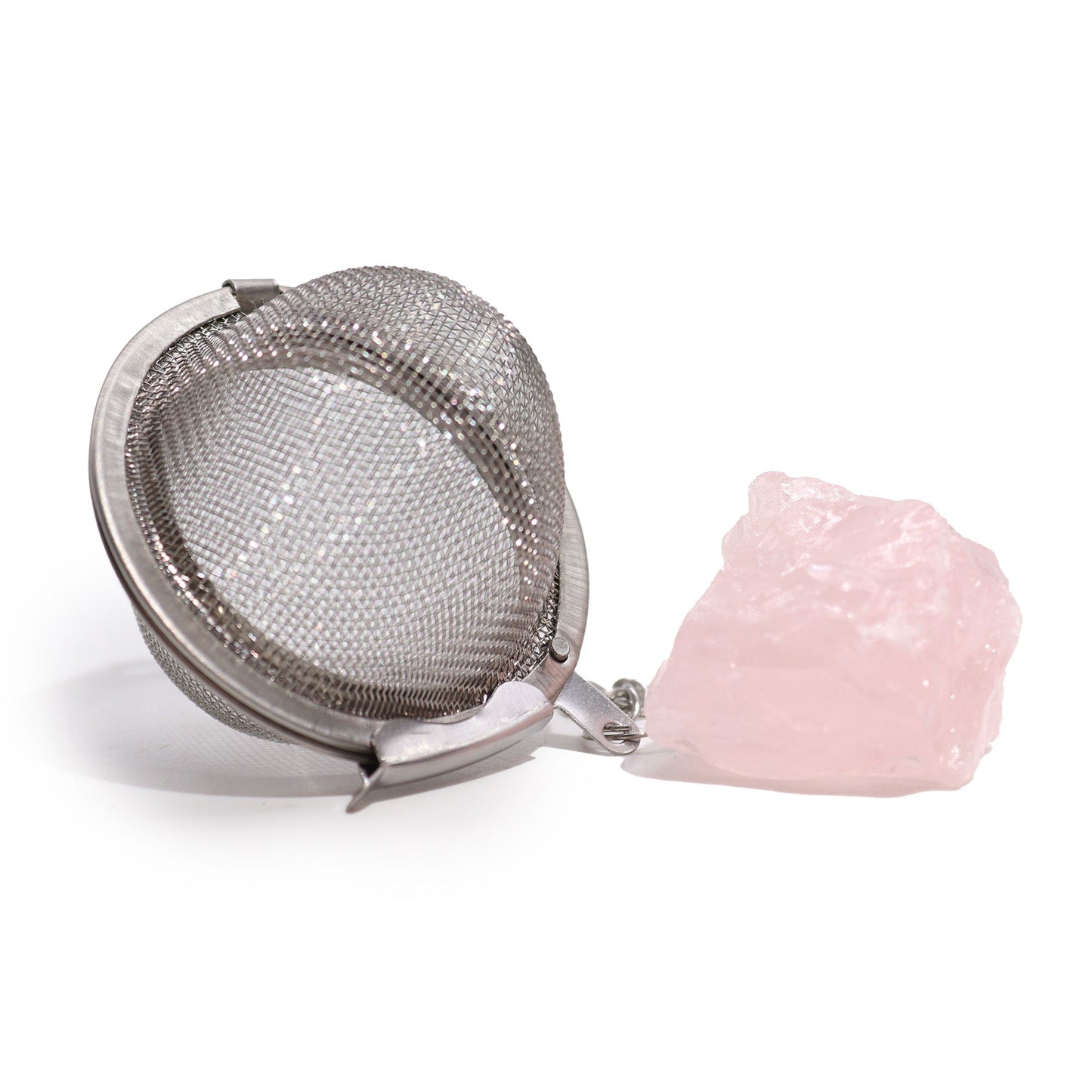 Silver stainless steel tea infuser ball on a chain with a raw pink Rose Quartz gemstone charm attached.