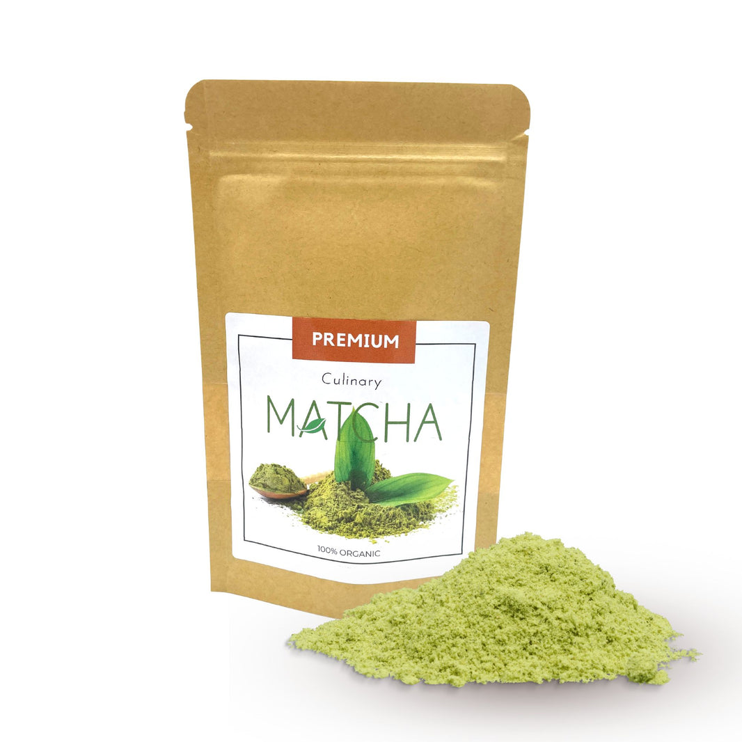 A small, eco-friendly stand-up pouch containing fine, vibrant green organic culinary-grade matcha powder.