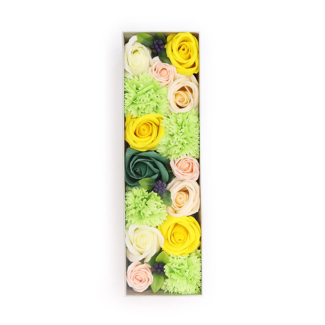 A long, rectangular gift box showcasing a beautiful arrangement of yellow and green soap flower blooms and foliage.