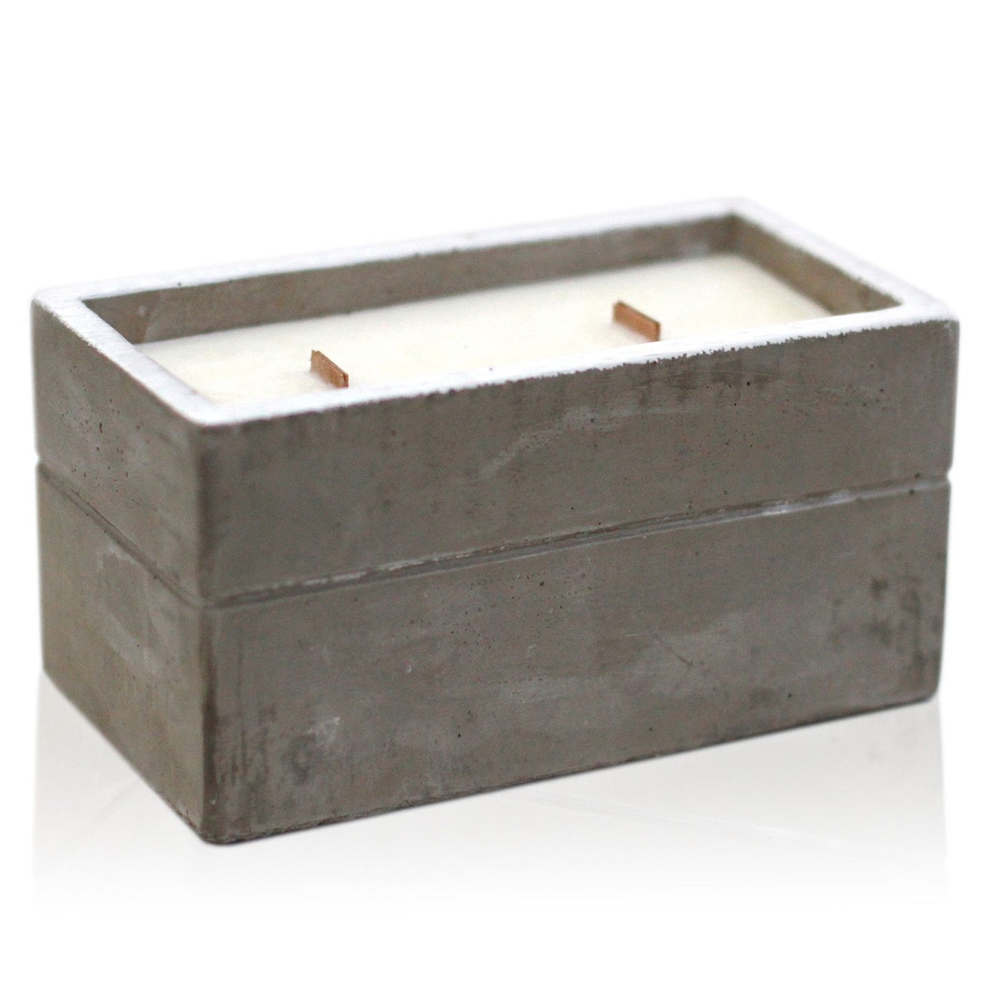 A large, rectangular grey concrete candle vessel with two wicks set in smooth white soy wax.