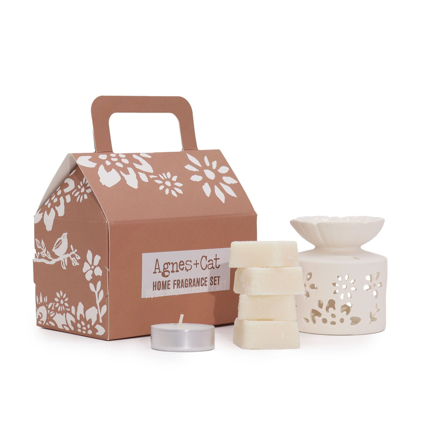 A stylish house-shaped gift box in earthy tones containing a selection of Moroccan-themed bath and fragrance products.