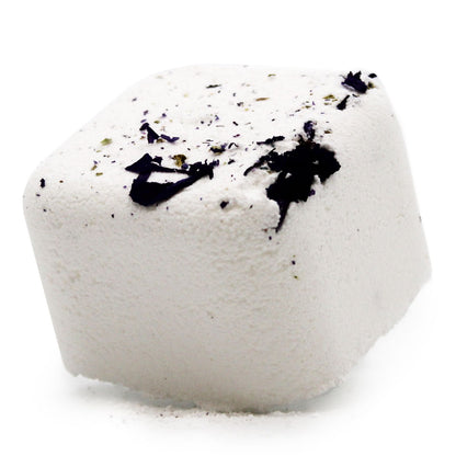 A white square shower steamer tablet with dark botanical speckles, designed to release uplifting essential oils.