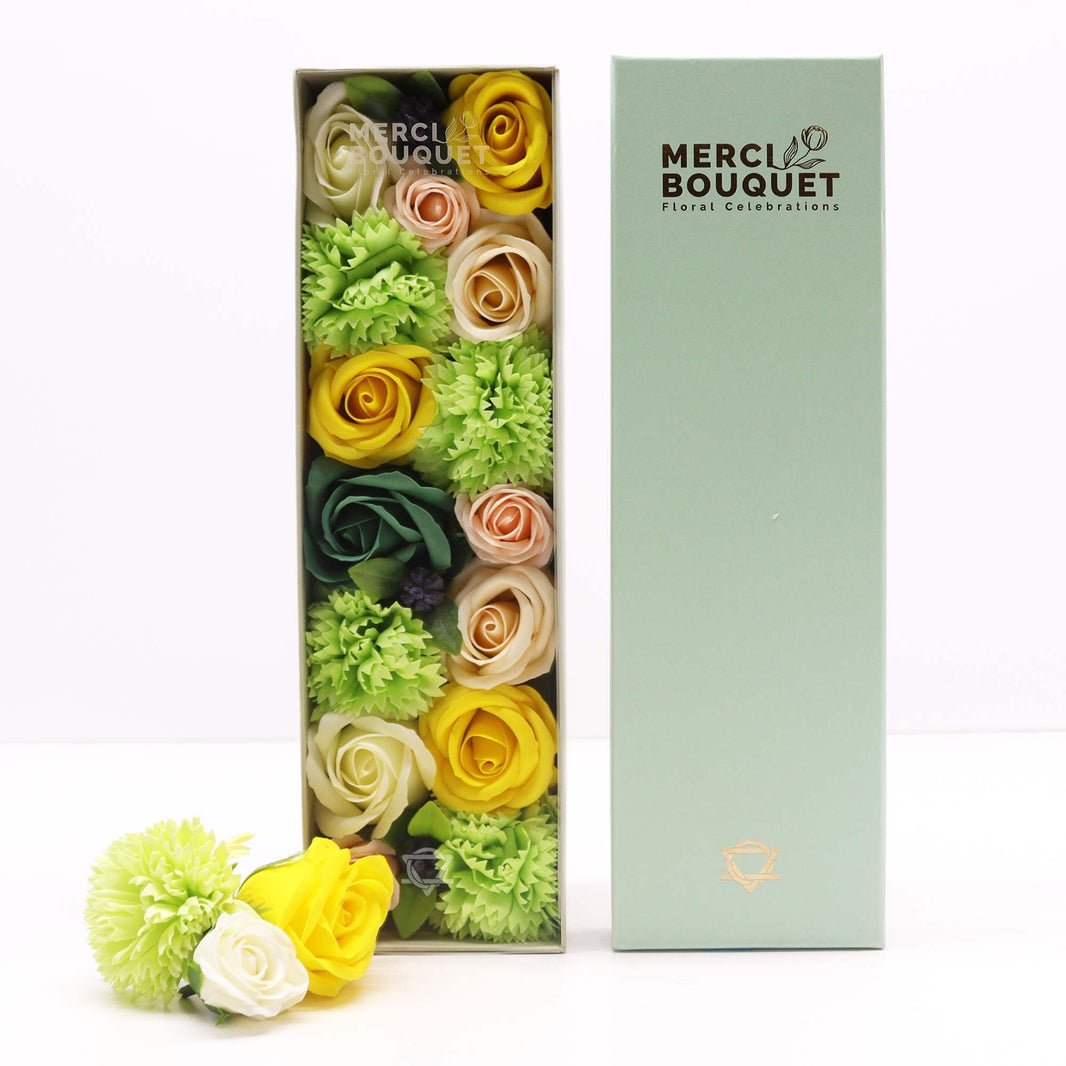 A long, rectangular gift box showcasing a beautiful arrangement of yellow and green soap flower blooms and foliage.
