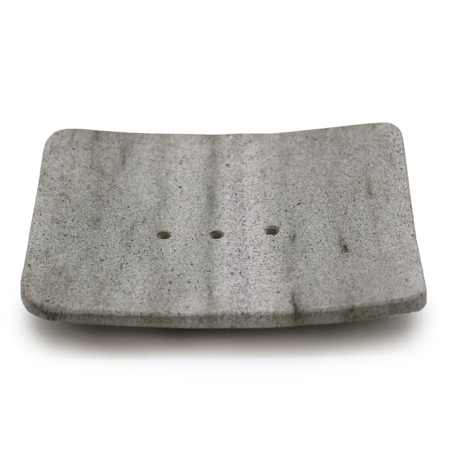 A square-shaped natural grey stone soap dish made from porous Zeolite (Ziolit) stone for quick-drying soap storage.