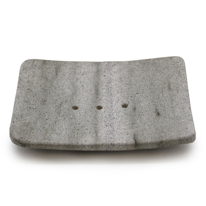 A square-shaped natural grey stone soap dish made from porous Zeolite (Ziolit) stone for quick-drying soap storage.