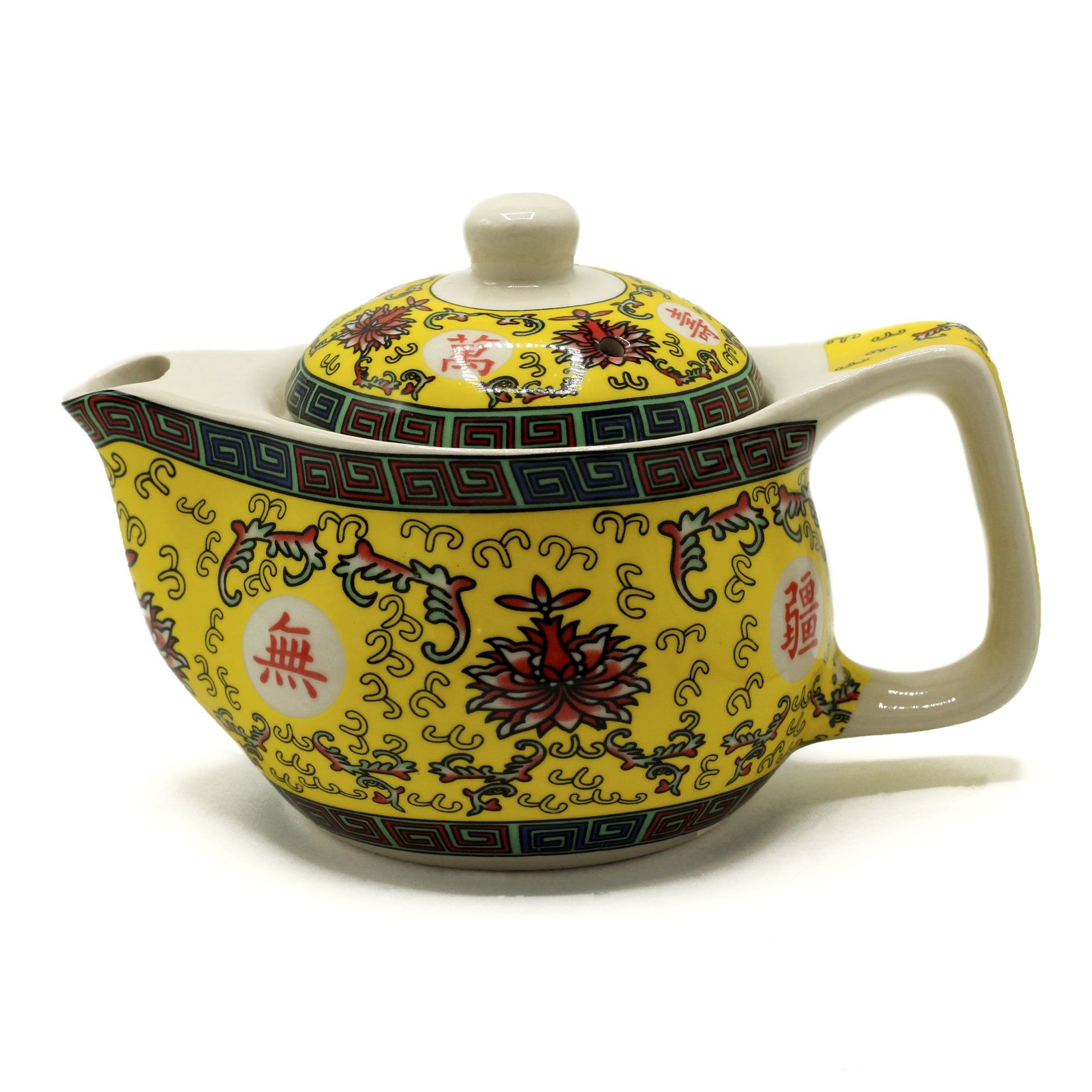 A small, ornate ceramic teapot featuring a vibrant yellow and green oriental pattern with a matching lid and curved handle.
