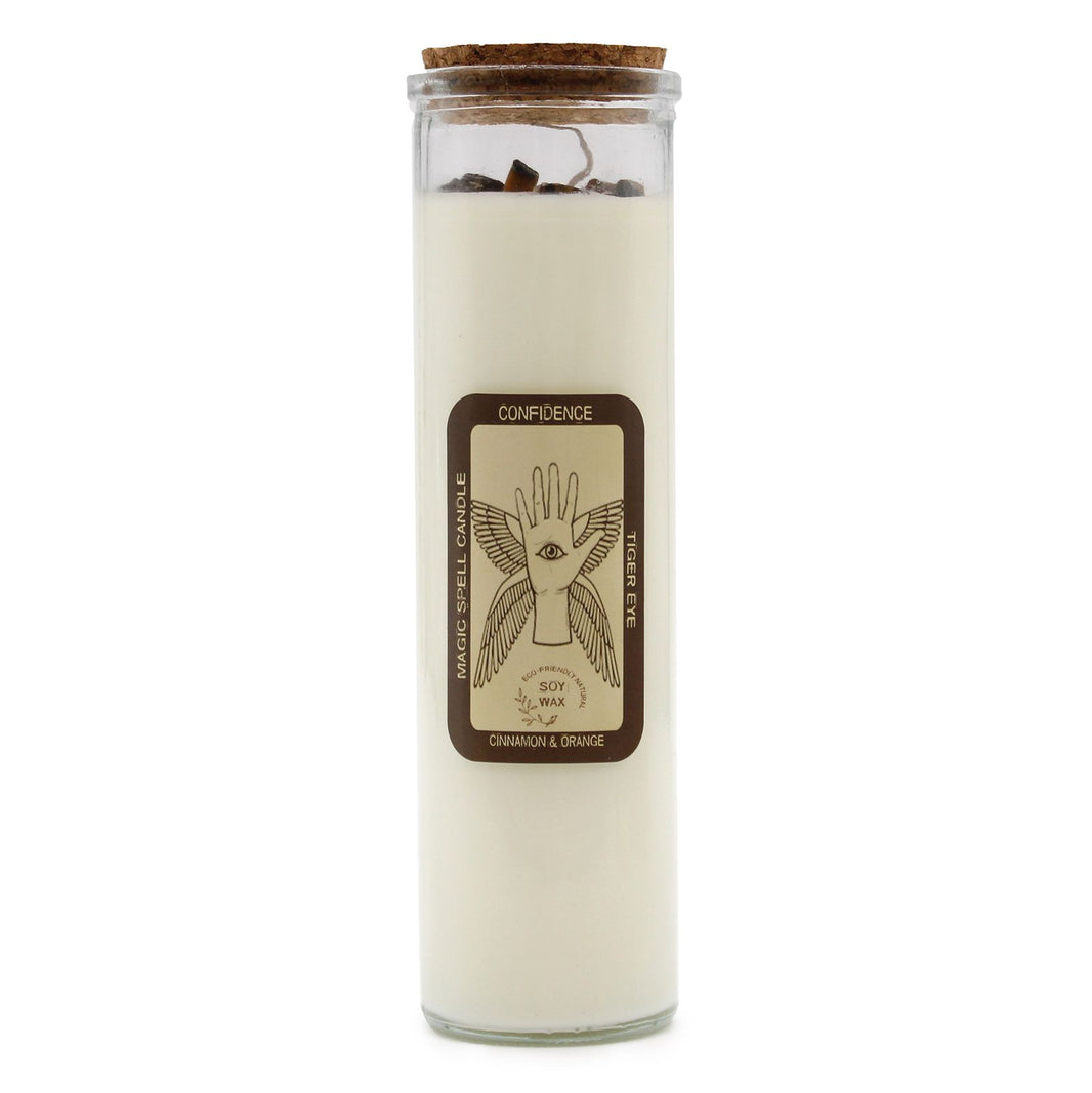A white ritual pillar candle with a 'Confidence' label featuring sun and lion motifs for empowerment.