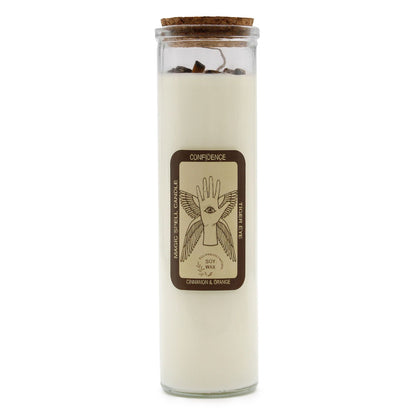A white ritual pillar candle with a 'Confidence' label featuring sun and lion motifs for empowerment.