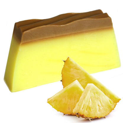 A 115g yellow and white layered artisan soap slice featuring a tropical pineapple fragrance and natural olive oil base.