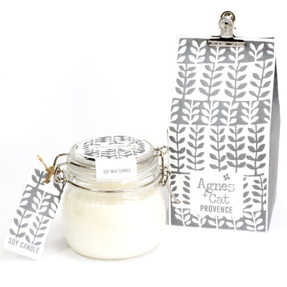 A traditional clear glass Kilner jar filled with a white scented candle and a purple-toned decorative tag with lavender illustrations.