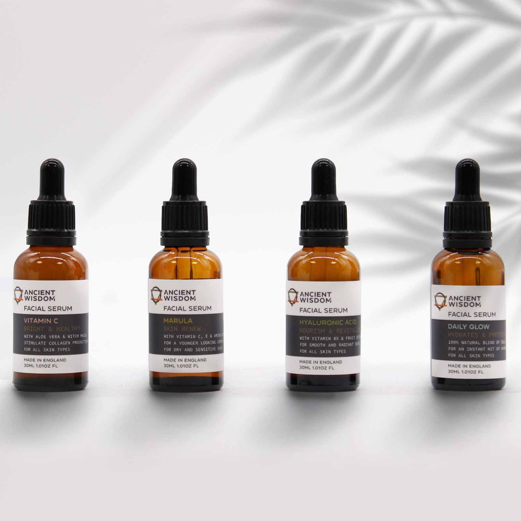 A professional amber glass dropper bottle of pure Marula oil serum, displayed with minimalist apothecary branding.