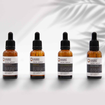 A professional amber glass dropper bottle of pure Marula oil serum, displayed with minimalist apothecary branding.