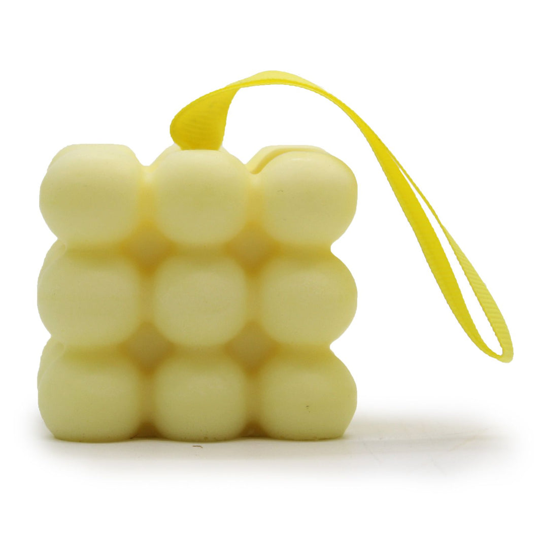 A yellow massage soap bar with a bubbly texture for muscle relief, featuring a hanging rope and fresh citrus scent.