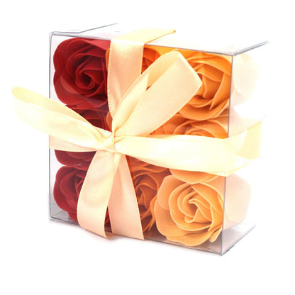 A square gift box filled with nine realistic peach-colored soap rose flowers arranged beautifully.