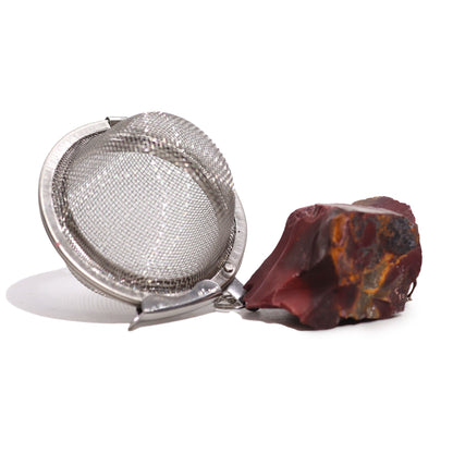 Silver mesh tea strainer ball with a raw earth-toned Mookaite gemstone charm on the end of the chain.