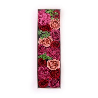 A luxury red long gift box filled with realistic antique-style pink and mauve soap roses arranged in a decorative display.