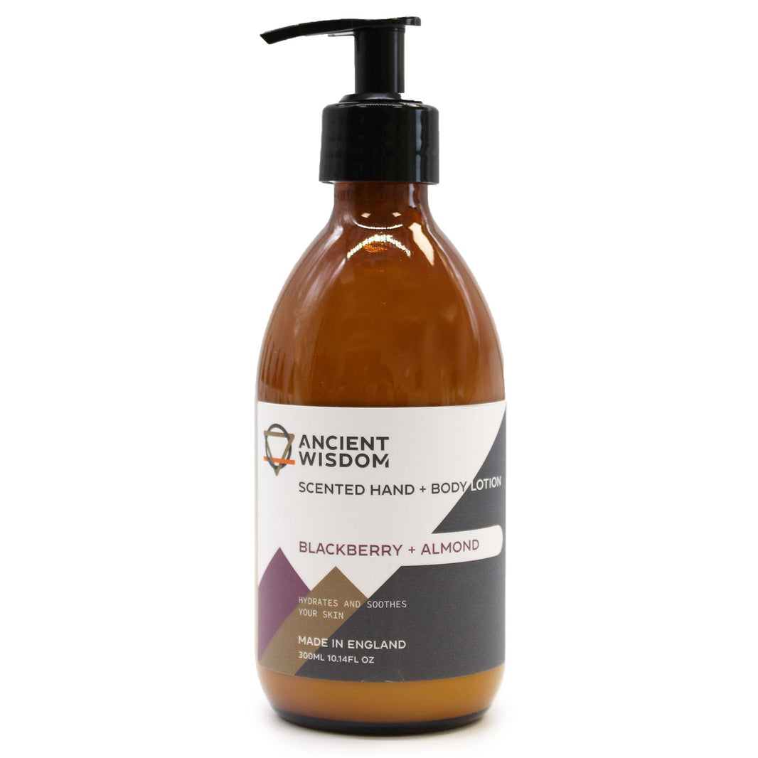 An amber glass pump bottle of blackberry and almond body lotion with a clean, professional white label.