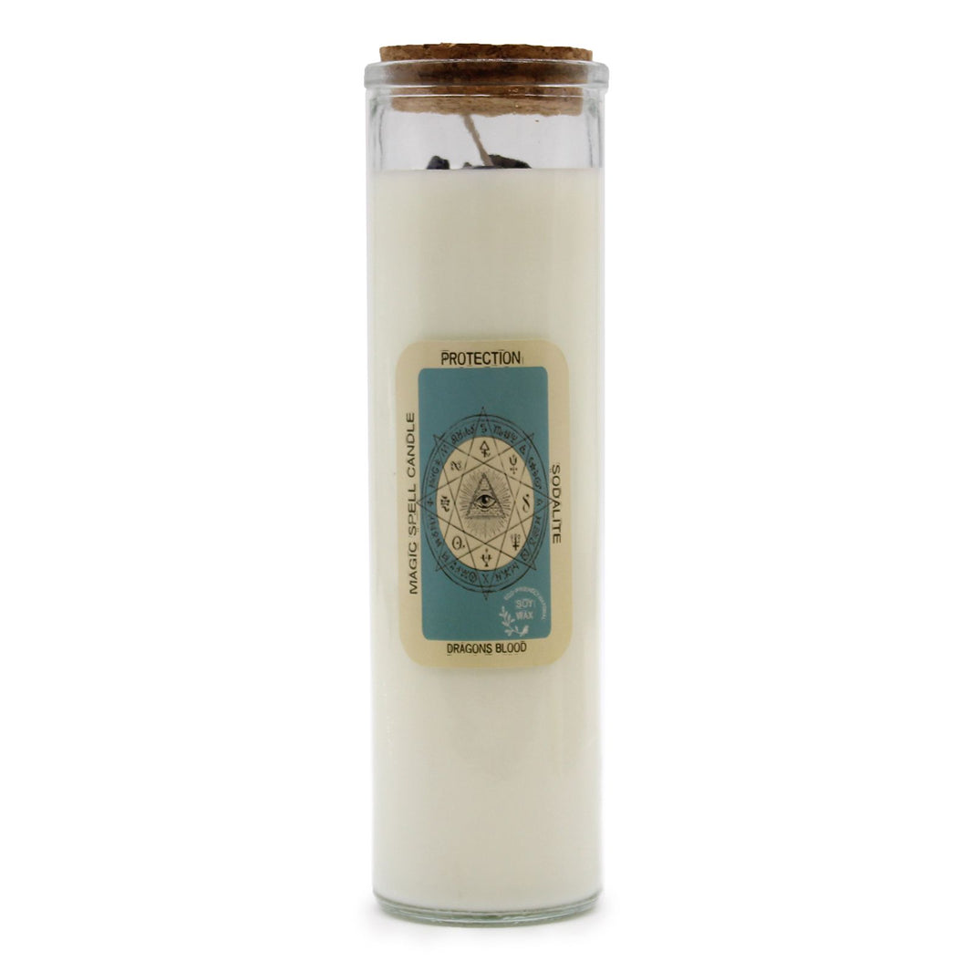 A tall white spell candle in a protective clear wrap with a mystical 'Protection' label and herb-inspired art.