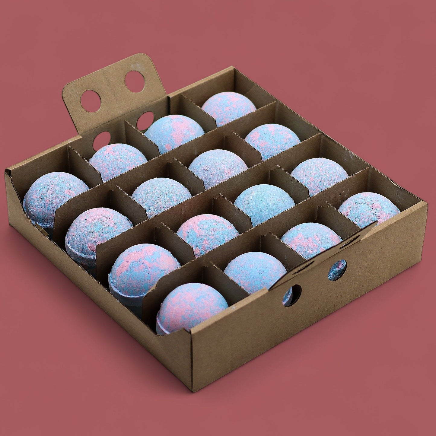 A wooden display crate holding sixteen large, marbled blue and white baby powder scented bath bombs.