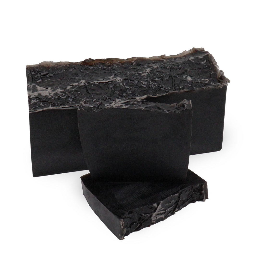 A sleek black artisan soap slice with a modern, minimalist design and a sophisticated, deep fragrance.