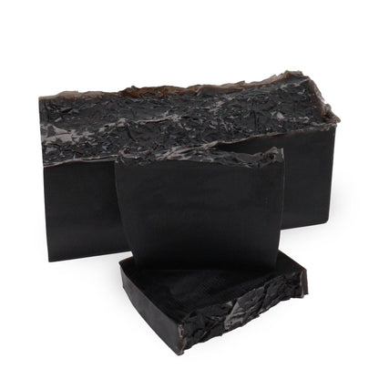 A sleek black artisan soap slice with a modern, minimalist design and a sophisticated, deep fragrance.