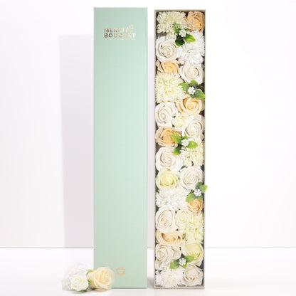 A tall, slender white gift box decorated with elegant gold and floral patterns, containing a selection of premium bath products.