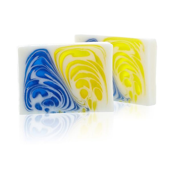 A 115g artisan soap slice featuring elegant blue and green swirls with a jasmine and green tea aroma.