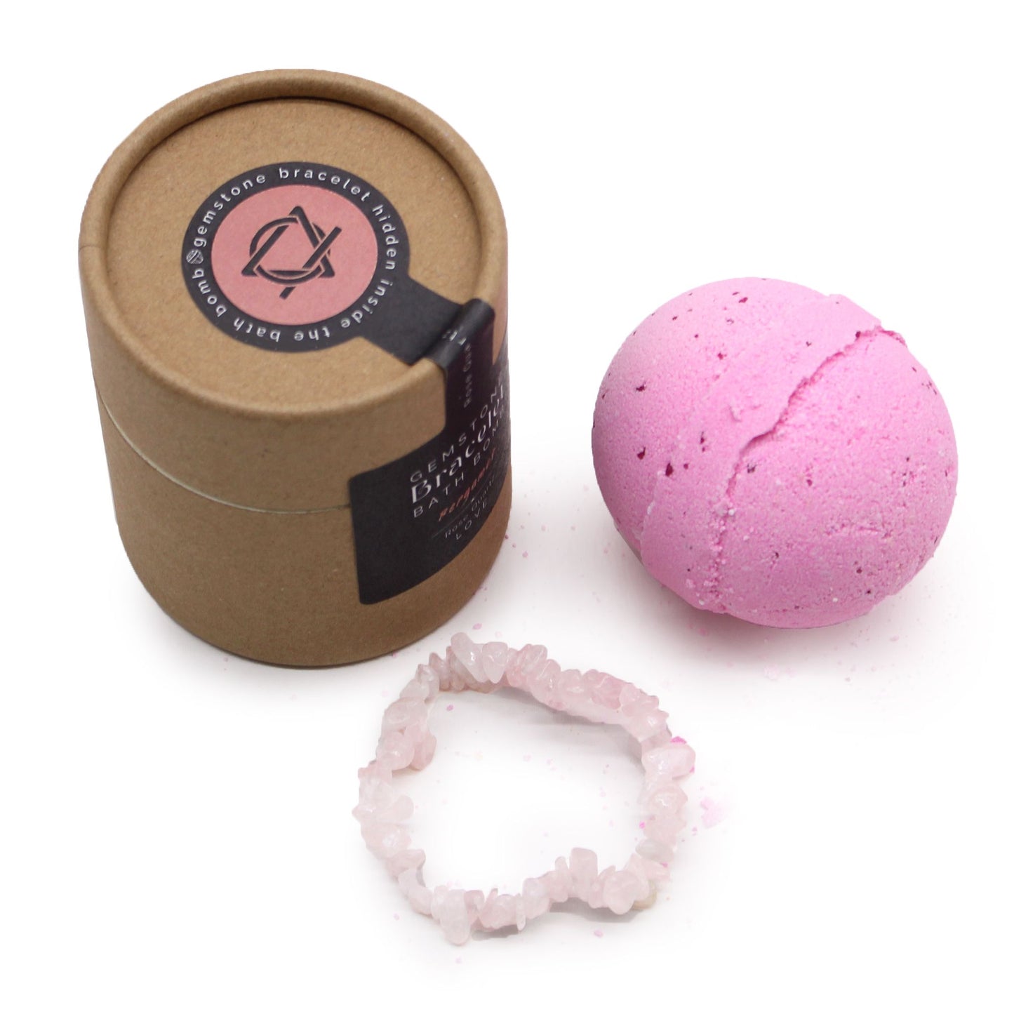 A 170g pink and white bath bomb with a genuine Rose Quartz gemstone bracelet shown as the hidden surprise gift inside.
