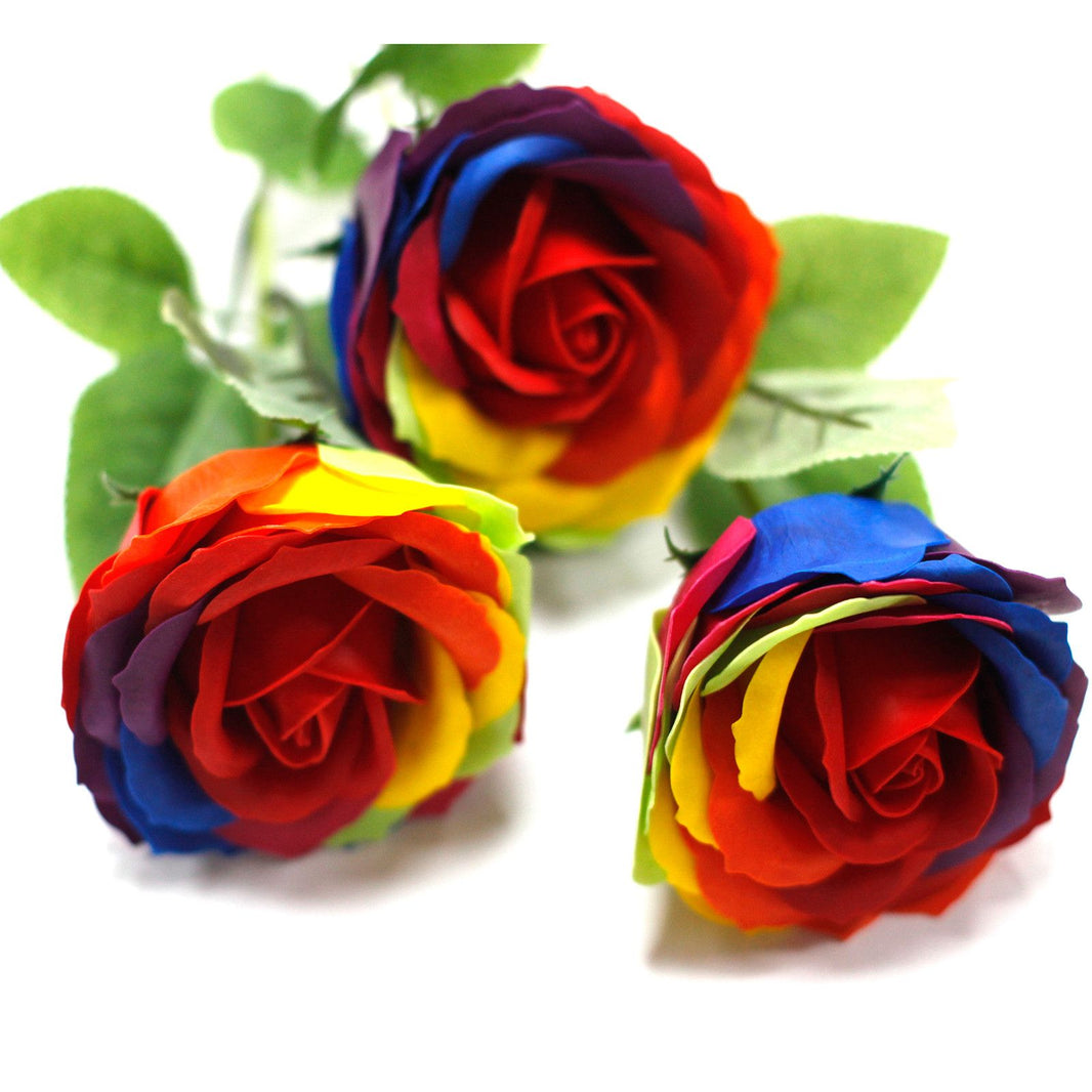 A large, realistic soap rose featuring vibrant petals in every color of the rainbow, presented as a single luxury gift bloom.