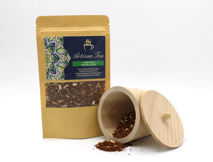 An eco-friendly cardboard tea tube featuring an exotic rooibos blend with visible dried fruit and floral petals.