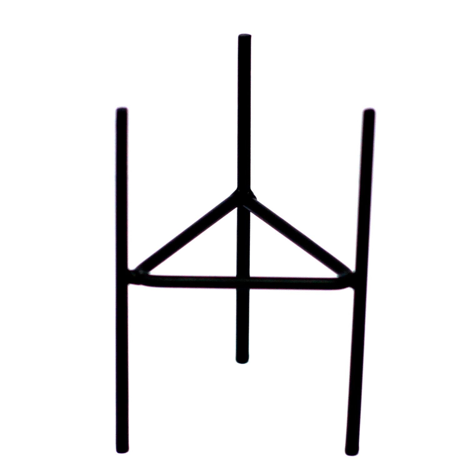 A black metal iron candle holder with a minimalist geometric design, perfect for holding botanical glass candles.