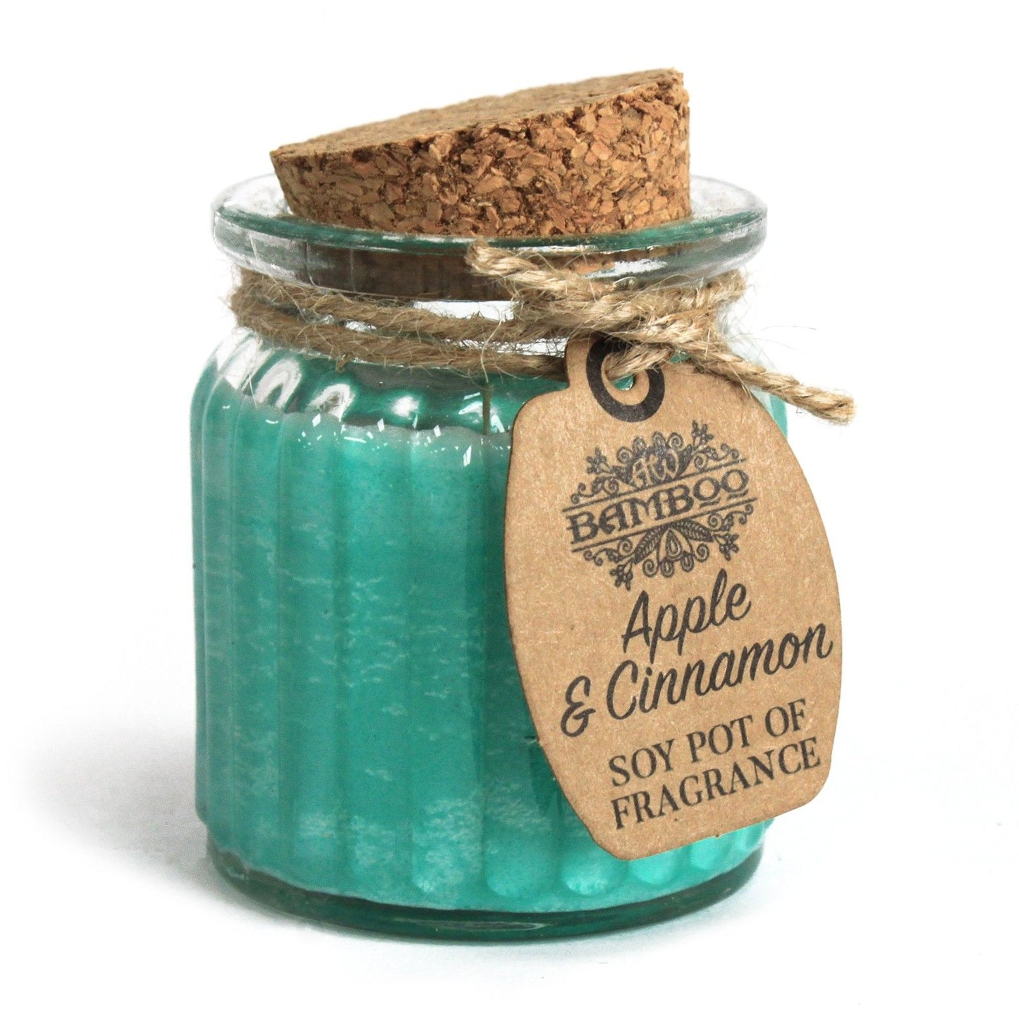 A small clear glass jar with blue-green tinted wax, a cork lid, and a hanging tag with apple and cinnamon stick graphics.