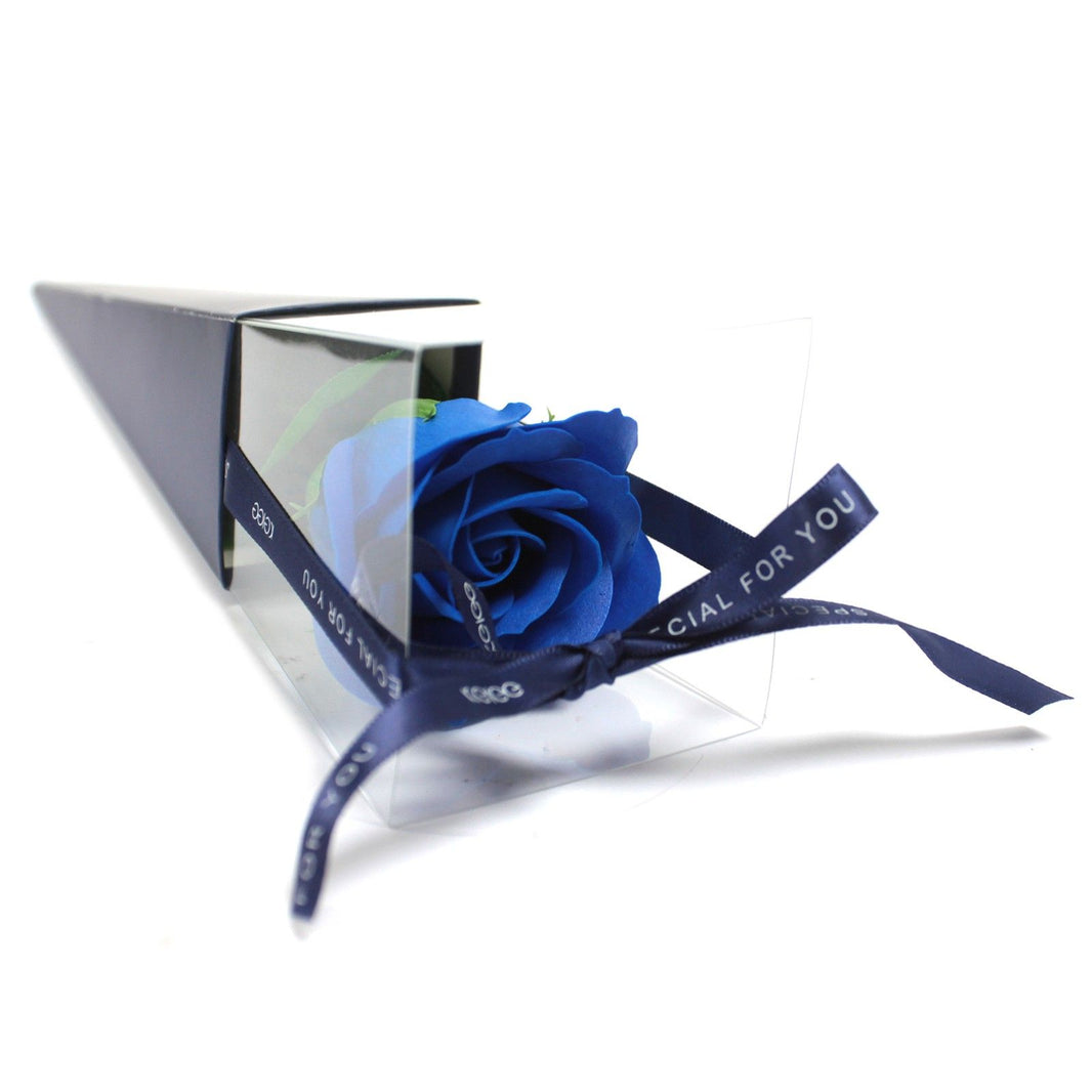 A single deep blue soap flower rose in a stylish, transparent triangular gift package.