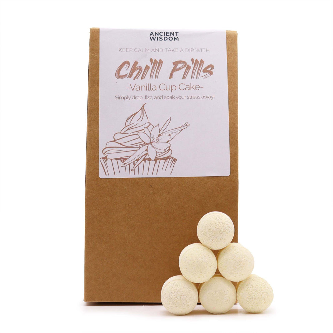 A kraft paper bag with a clear window revealing numerous small, white vanilla-scented bath bomb "pills."