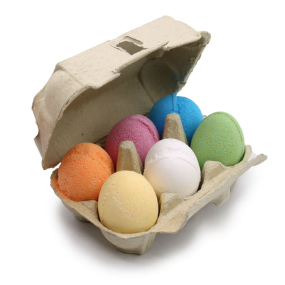 A cardboard egg carton filled with six different colored egg-shaped bath bombs, perfect for a Spring or Easter gift set.