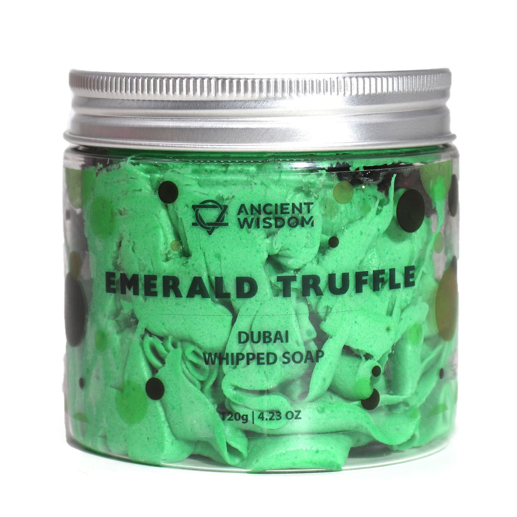 A glass jar filled with vibrant, aerated green whipped soap featuring a luxurious truffle-inspired texture and a silver lid.