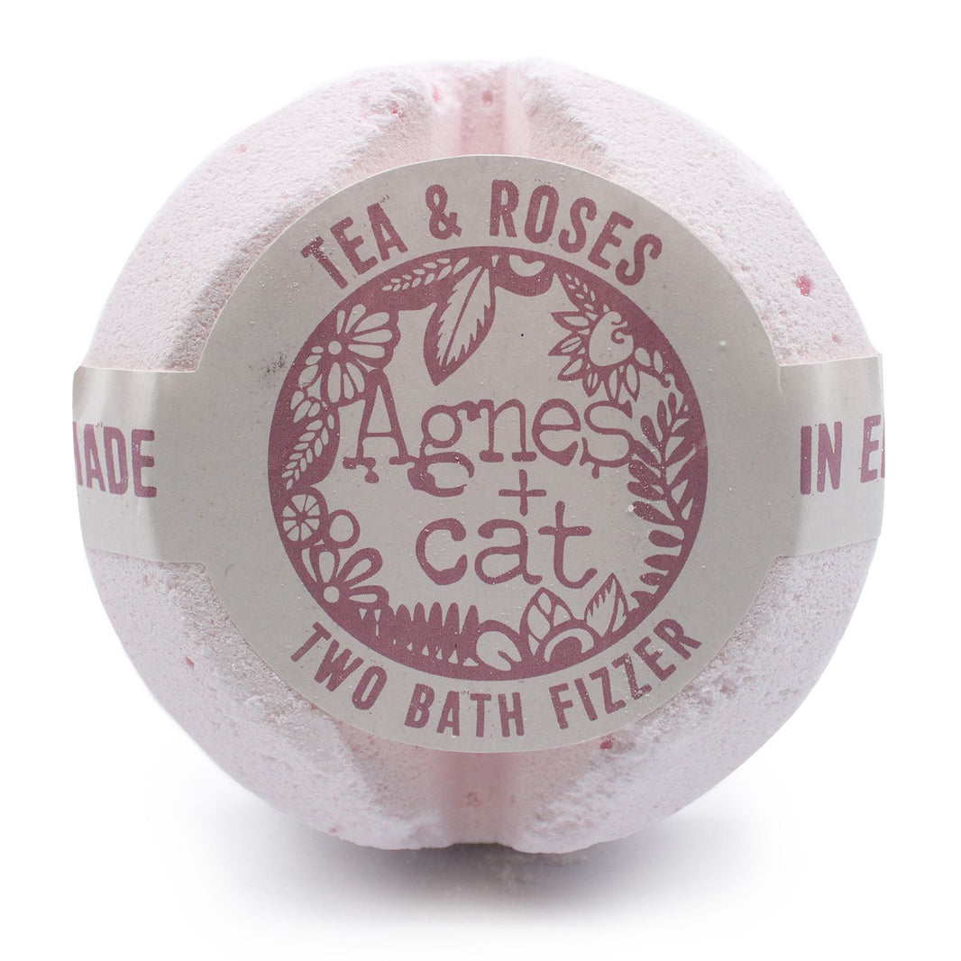 A jumbo 200g bath fizzer with a pale pink label showcasing elegant rose and tea leaf designs.