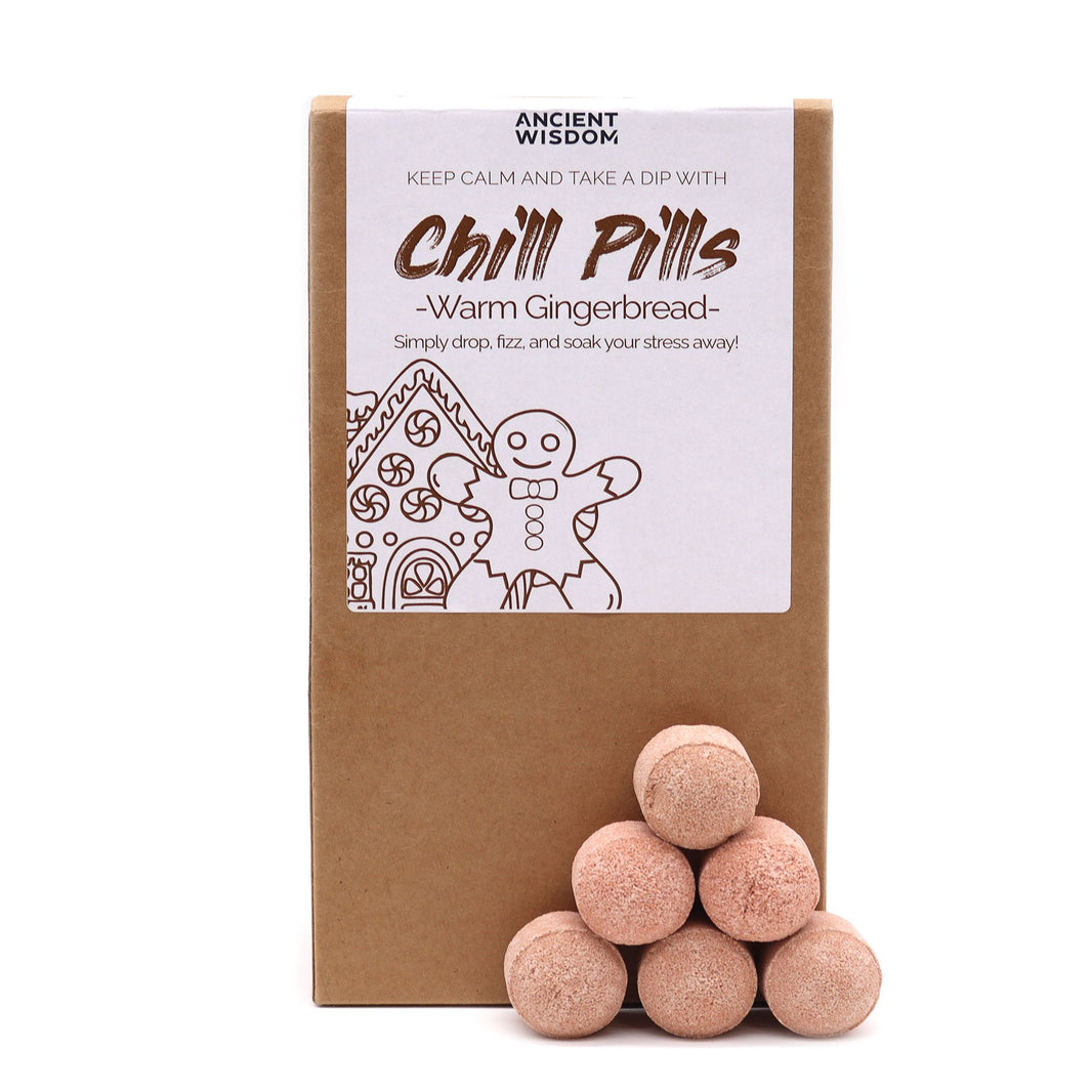 A brown kraft paper bag with a viewing window showing peach-colored mini bath bombs labeled Warm Gingerbread Chill Pills.
