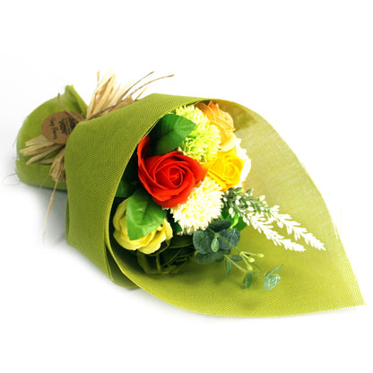 A standing floral arrangement featuring green and yellow soap roses and carnations wrapped in decorative paper.