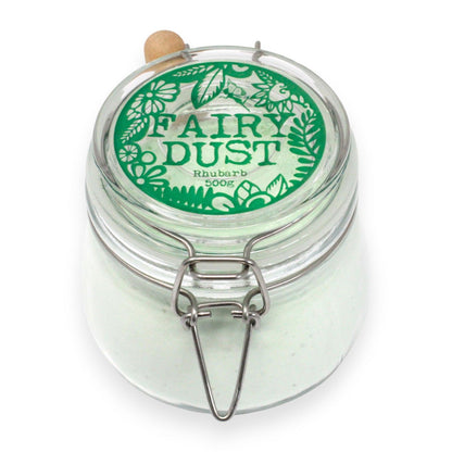 A large apothecary-style glass jar filled with 500g of white bath fizzing powder and a small wooden measuring scoop.