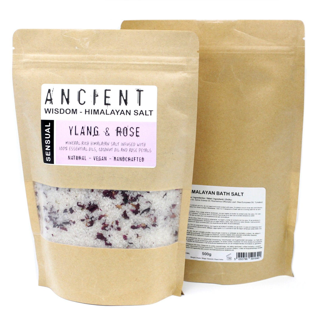 A 500g kraft paper bag of pink Himalayan salts mixed with dark botanical petals and romantic essential oils.