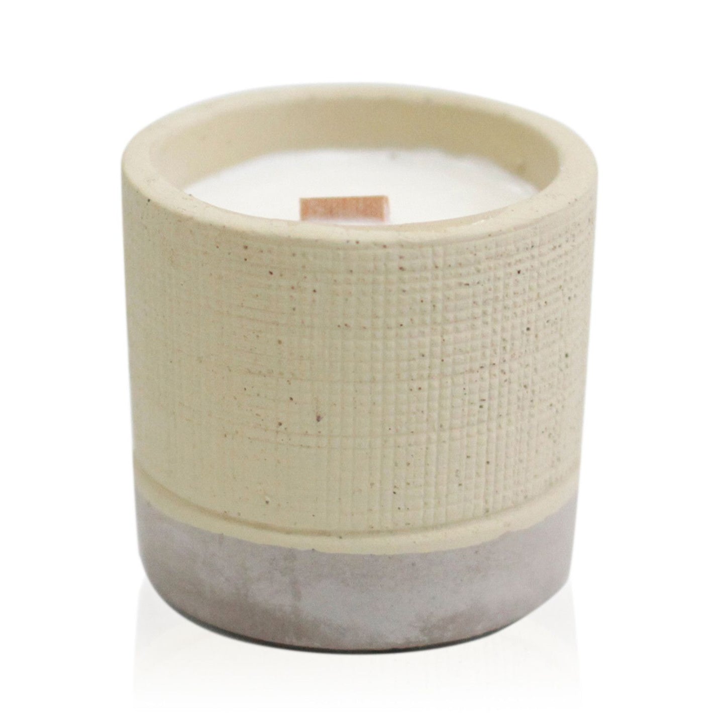 A minimalist grey concrete pot containing a hand-poured soy candle with a smooth, industrial aesthetic.